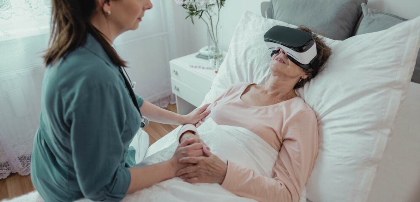 Love in action - nurse with patient undergoing virtual reality therapy