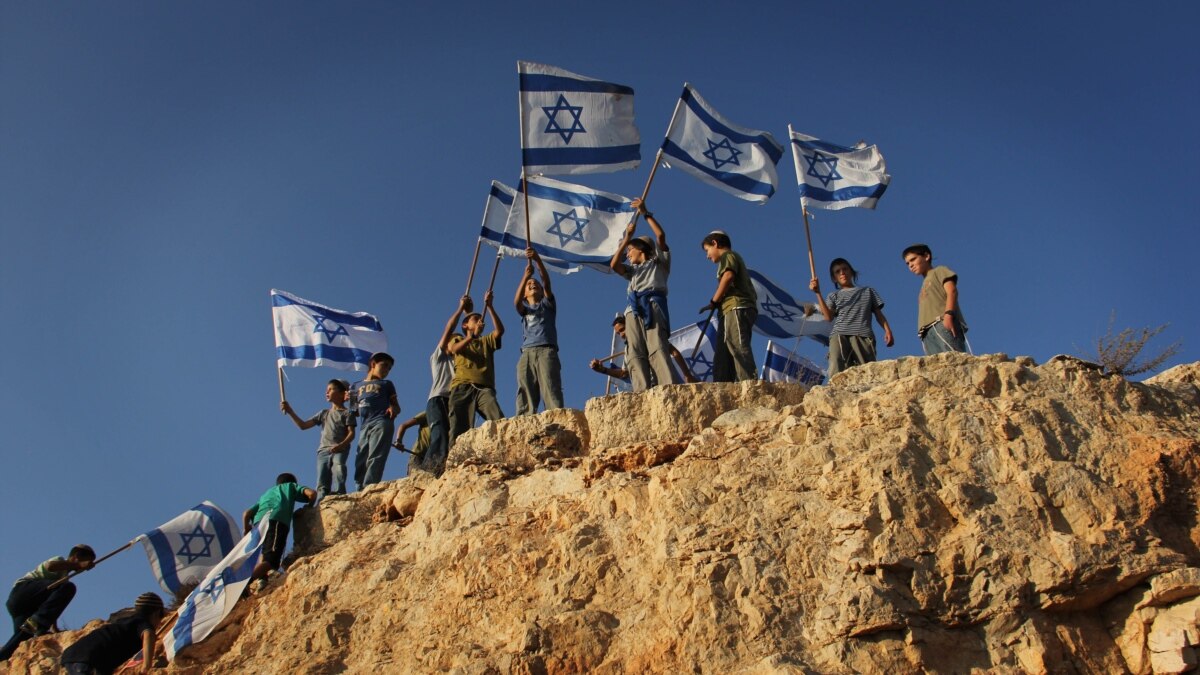Israeli children standing on rock edge