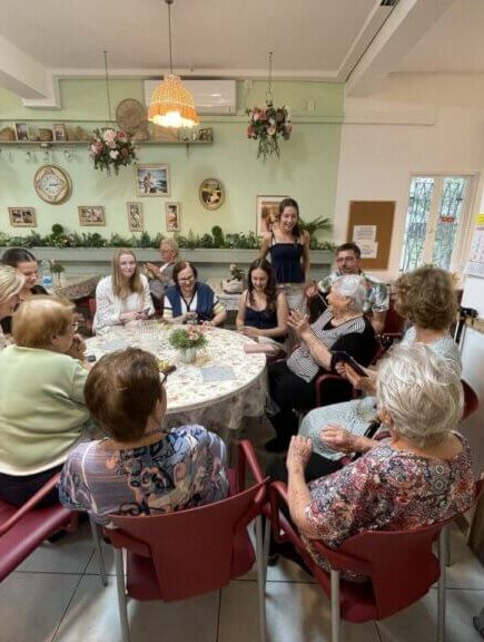 German young people visit with survivors