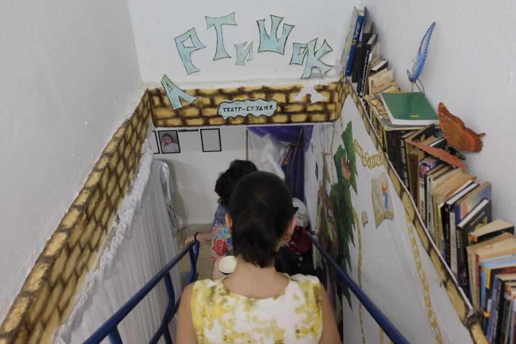 The ICEJ delegation heads downstairs to the renovated underground shelter serving as a youth center.