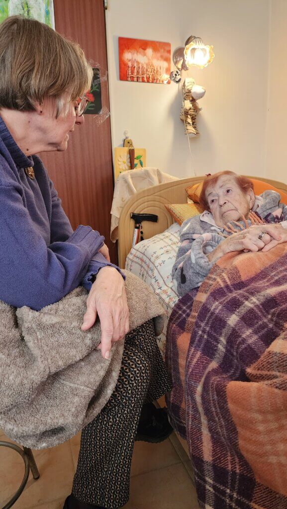 Corrie sits and chats with Luba.
