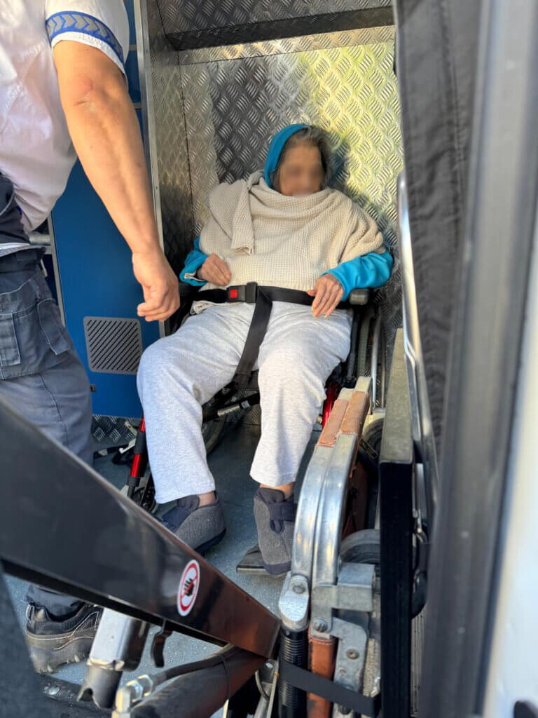 Holocaust survivor is transported via ambulance