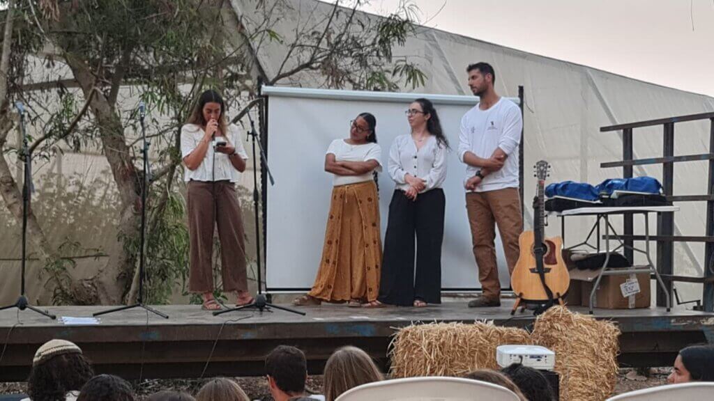 Students share their speeches on a makeshift pallet truck stage