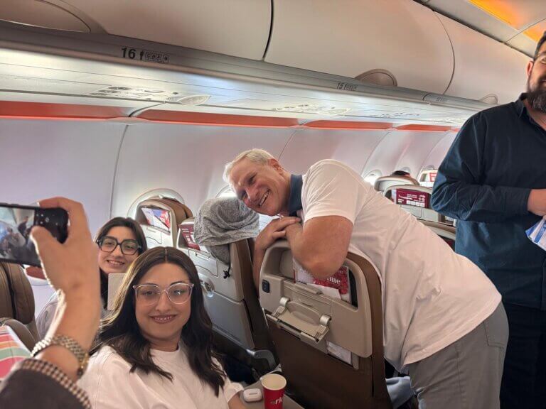 Robert Baxter chats with the Jewish immigrants on the plane