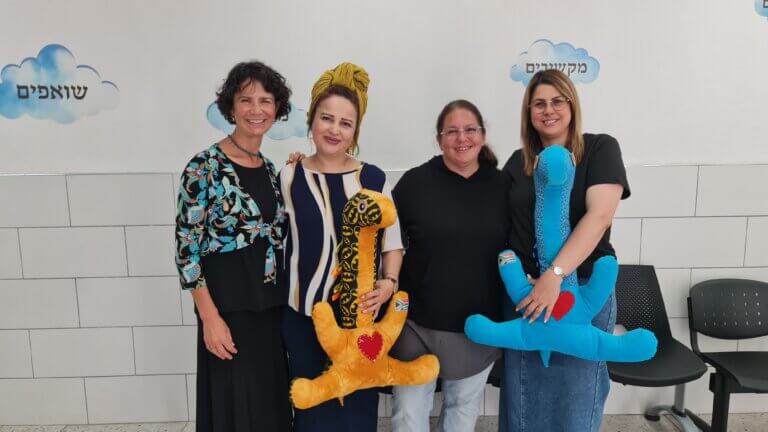 Jannie with school staff Yehudit, Vale, and Lucy hold “Ollies“