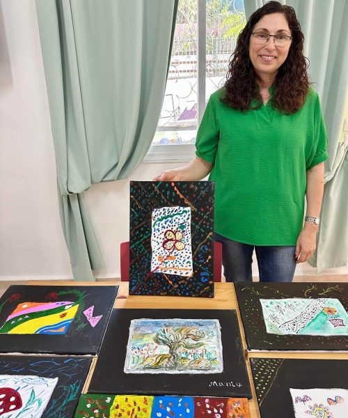 Nancy, the ICEJ Home’s art therapist, with some of the residents’ artwork.